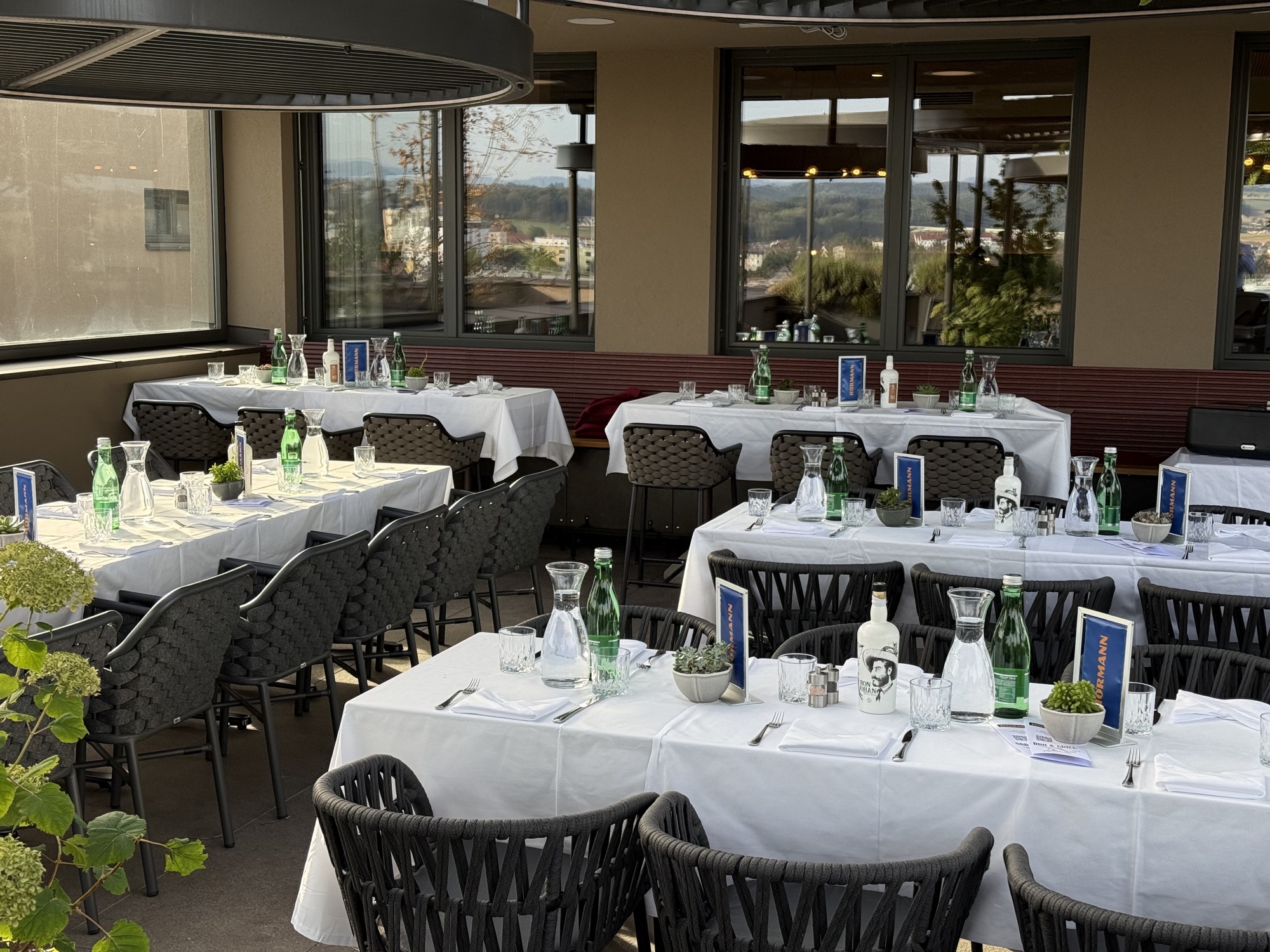 Gedeckte Tafeln bei einem Sommerfest auf der Dachterrasse des Hafnerhotels